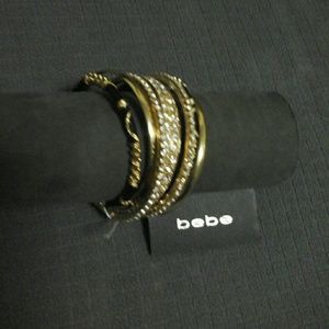 BEBÉ MAJESTIC BLACK AND GOLD RHINESTONE BRACELET.